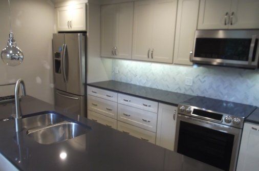 kitchen remodeling completed  white cabinets center island faucet